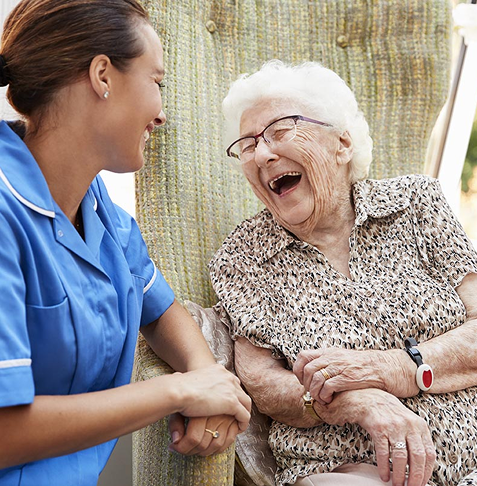 Professional caregiver assisting woman with non-medical home care for seniors.