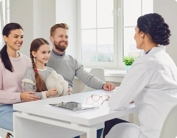 Family consulting with a doctor in a bright office.